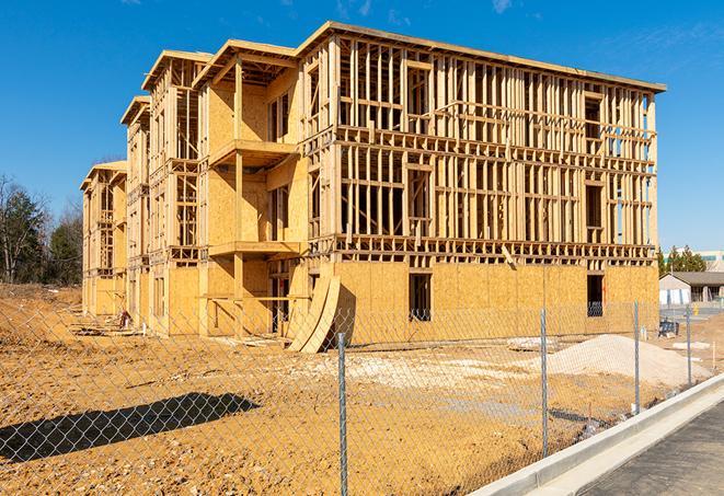 a close-up of temporary chain link fences enclosing a job site, signaling progress in the project's development in Hawaiian Gardens, CA